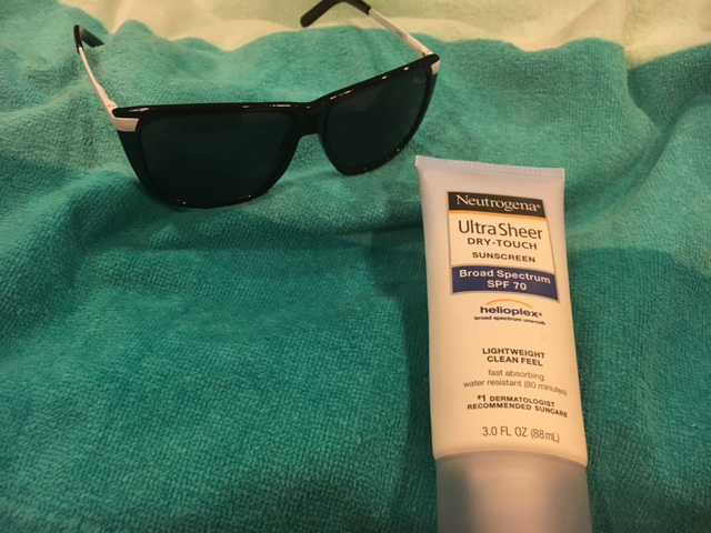 Neutrogena sunscreen laying on towel
